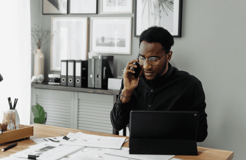 A man knowing how to get a loan with no credit check calling an online lender to apply